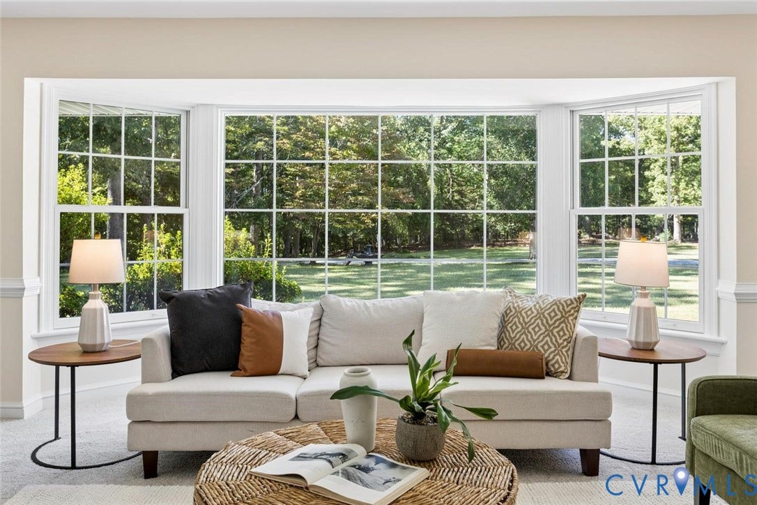 Bay window with multiple paneled windows and extensive exterior greenery
