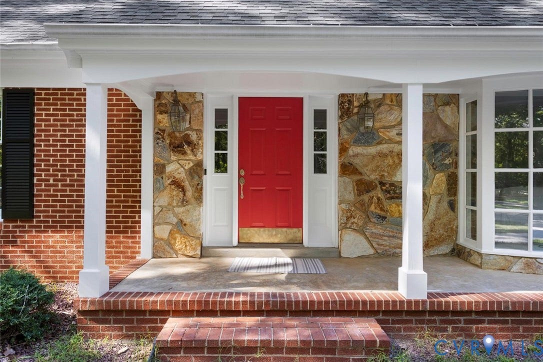 Brick and stone facade with a covered entry