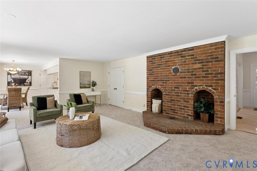 Expansive living area with a floor-to-ceiling brick fireplace featuring two arched niches