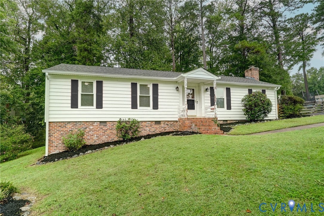 2602 Seacliff Court, Richmond, VA 23236 White siding exterior with brick foundation, featuring a covered porch entry, dark shutters, and a brick chimney