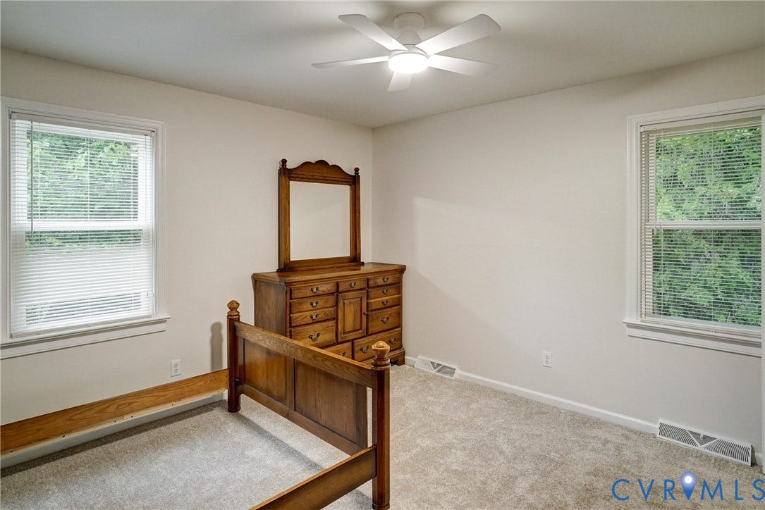 2602 Seacliff Court, Richmond, VA 23236 Carpeted flooring with white walls, two windows with white blinds, and a ceiling fan with integrated lighting