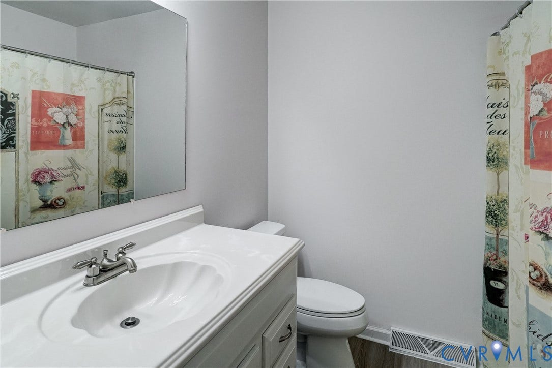 2602 Seacliff Court, Richmond, VA 23236 White vanity with an integrated sink and chrome faucet