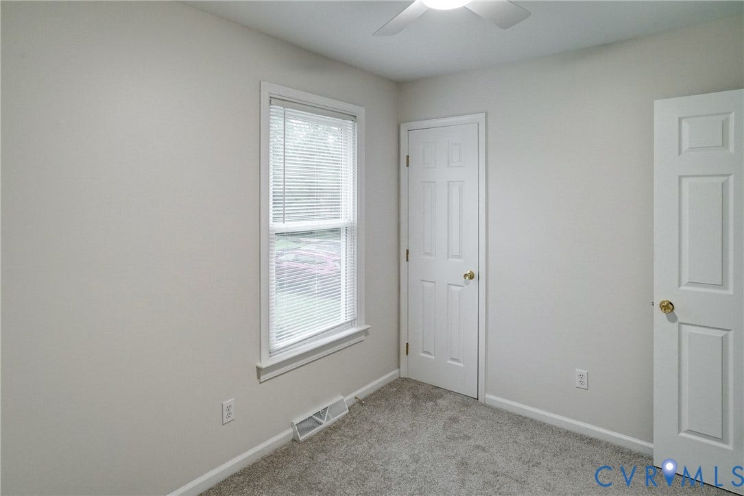 2602 Seacliff Court, Richmond, VA 23236 Bedroom 2,Neutral-toned walls with a single window, accompanied by light gray carpeting and a white paneled door
