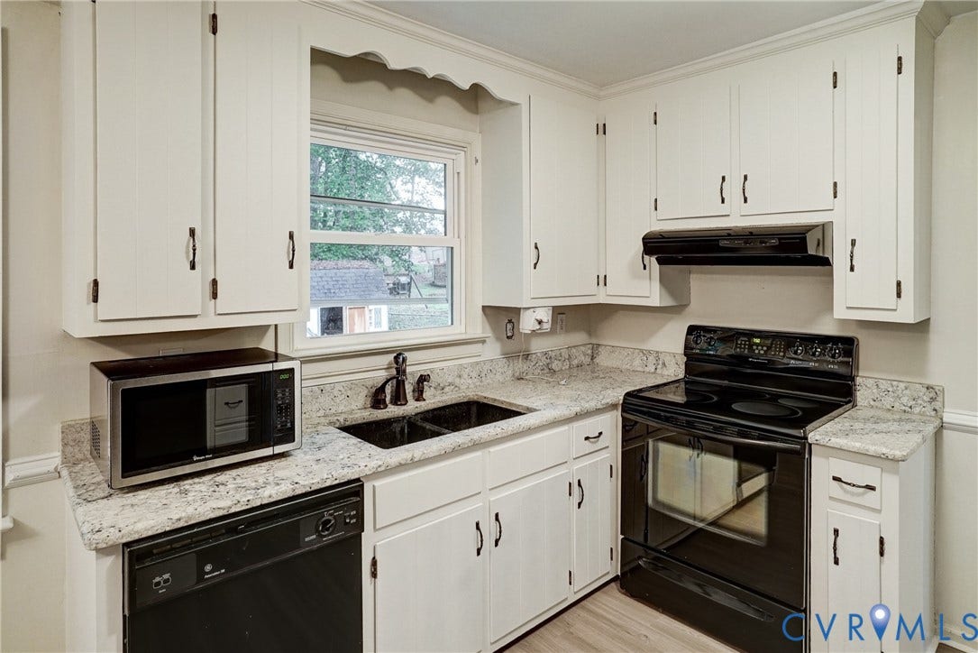2602 Seacliff Court, Richmond, VA 23236 White cabinetry with dark hardware, a double basin sink with a dark faucet, solid surface countertops, and a black electric range with an overhead vent hood