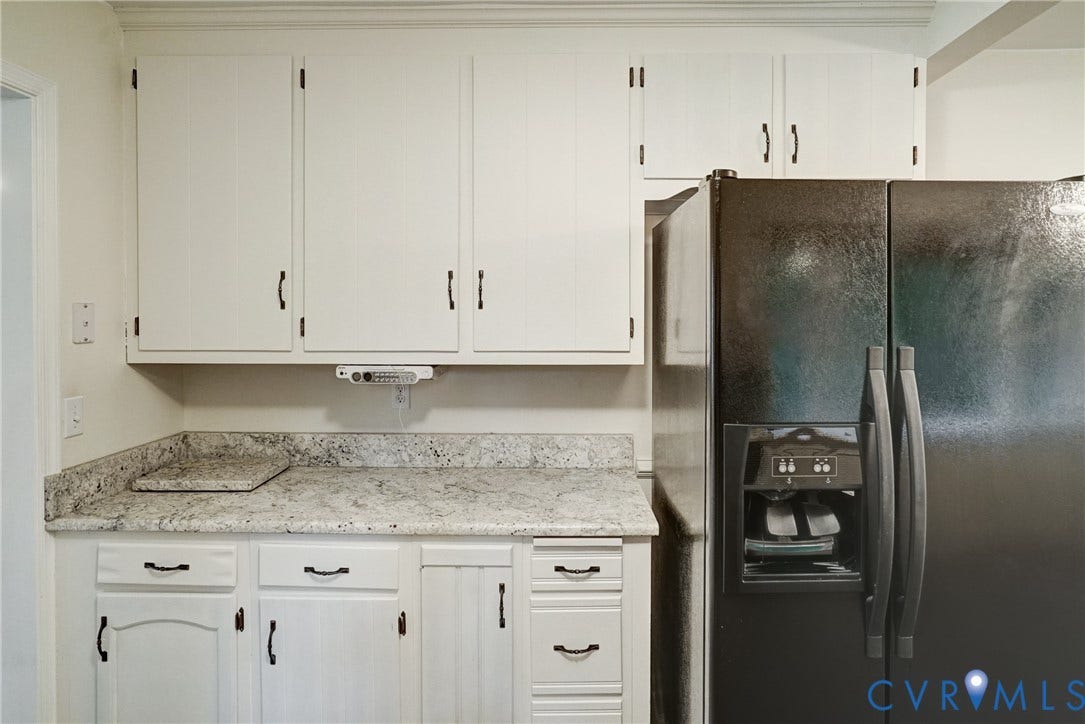 2602 Seacliff Court, Richmond, VA 23236 White upper and lower cabinetry, light-toned countertop, and built-in refrigerator