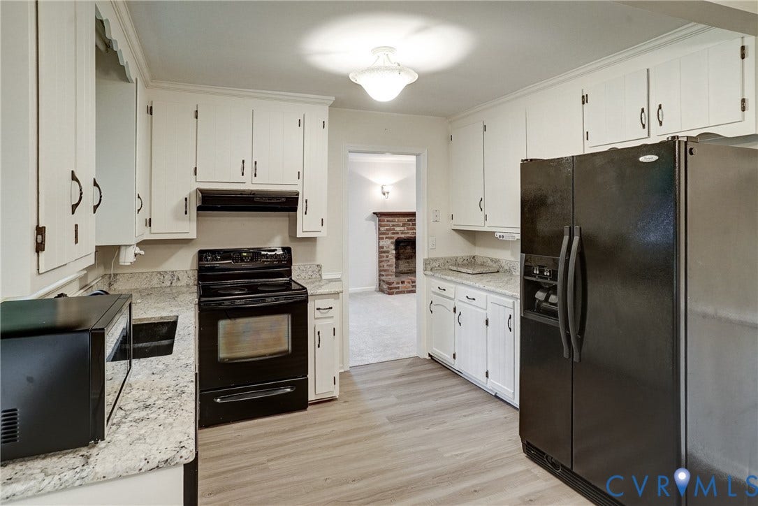 2602 Seacliff Court, Richmond, VA 23236 Kitchen featuring white cabinetry, light-toned countertops, wood-finish flooring, and black appliances