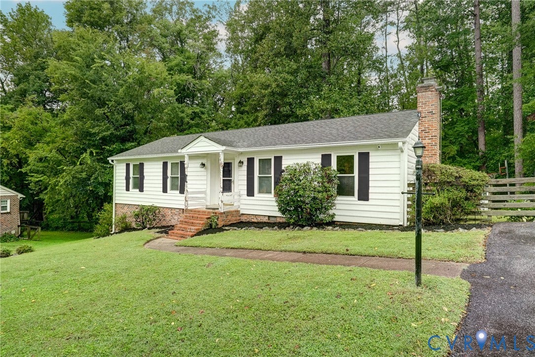 2602 Seacliff Court, Richmond, VA 23236 White siding exterior with dark shutters, gabled entry, and a brick chimney