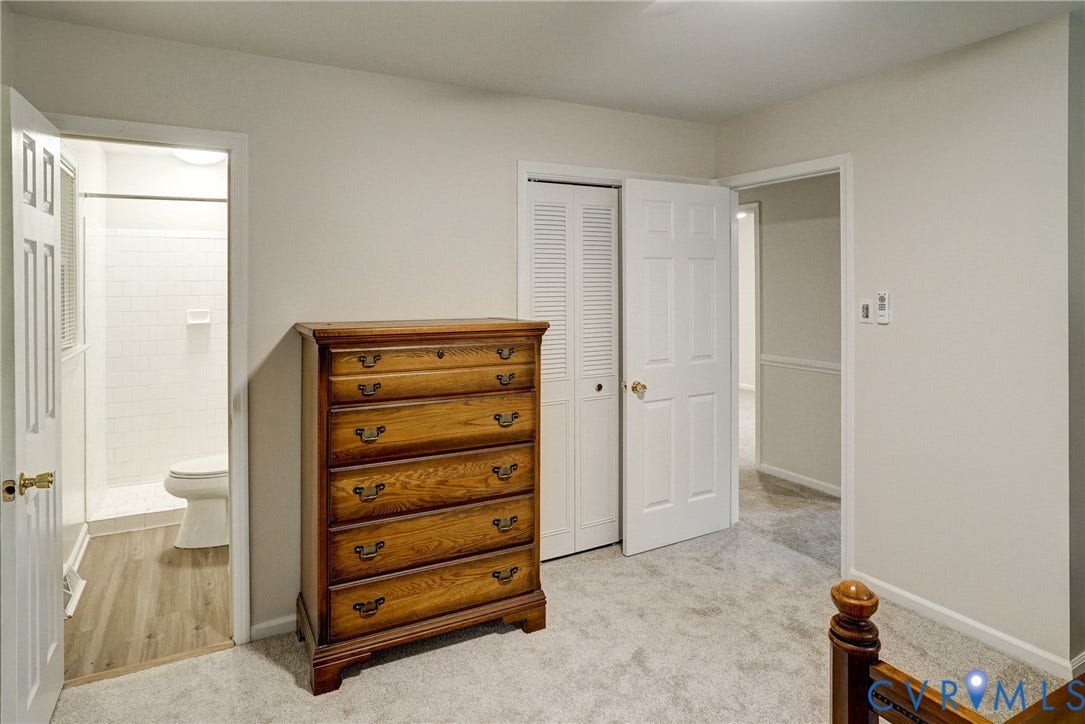 2602 Seacliff Court, Richmond, VA 23236 Carpeted room with a full bathroom featuring wood-finish flooring and white subway tile shower surround