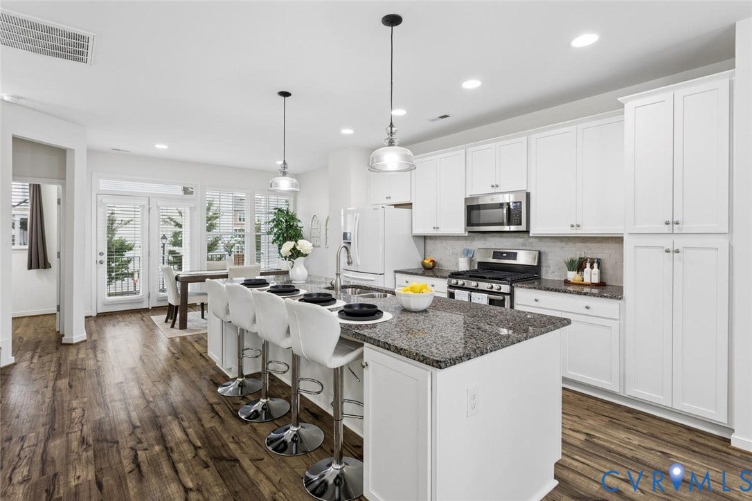 10420 Perennial Drive, Ridgefield Green Townhome, Henrico, VA 23233 Kitchen with dark wood-finish flooring, white cabinetry, a large kitchen island with a dark countertop, stainless steel appliances, and double glass doors