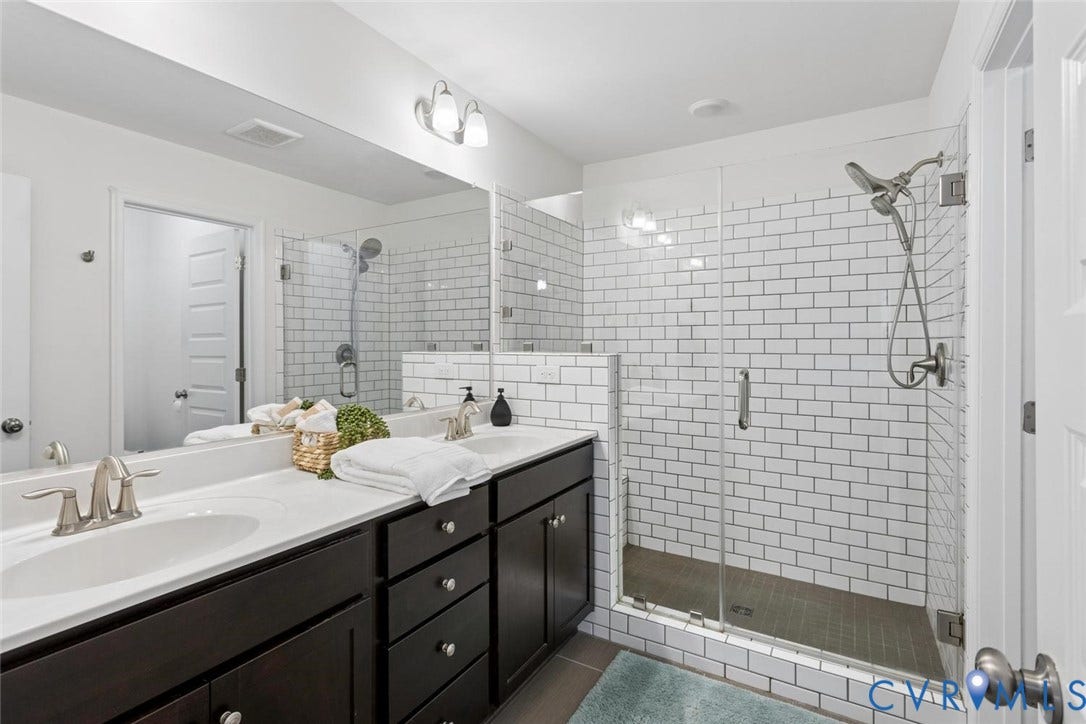 10420 Perennial Drive, Ridgefield Green Townhome, Henrico, VA 23233 Dual vanity with undermount sinks, wall-mounted mirror, brushed nickel fixtures, and dark wood-finish cabinetry