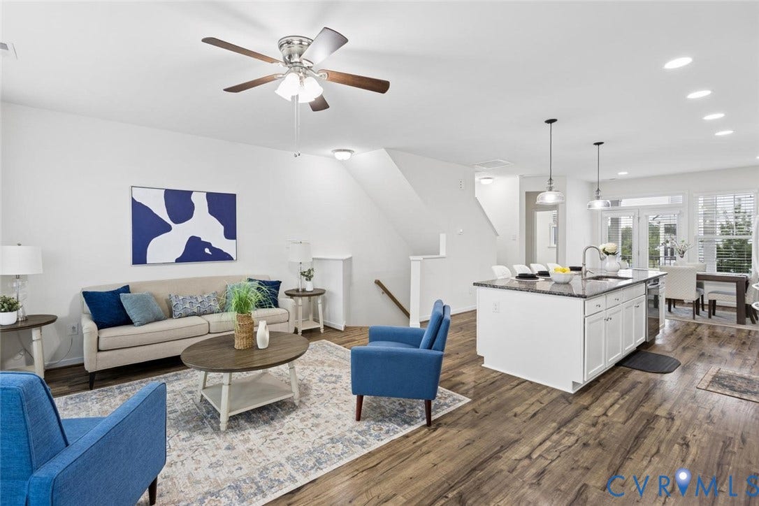 10420 Perennial Drive, Ridgefield Green Townhome, Henrico, VA 23233 Wood-finish flooring, white kitchen cabinetry, dark countertop island with sink, recessed ceiling lighting, and a ceiling fan with light fixture
