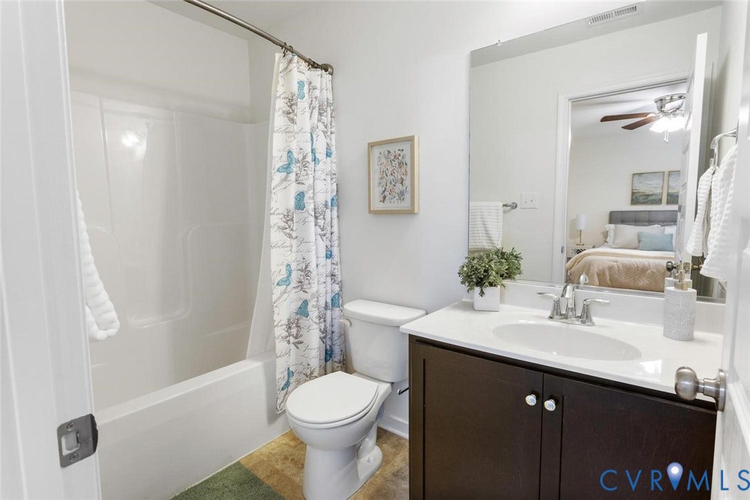 10420 Perennial Drive, Ridgefield Green Townhome, Henrico, VA 23233 White bathtub/shower combination, dark wood-finish vanity with white countertop, chrome faucet, and white toilet