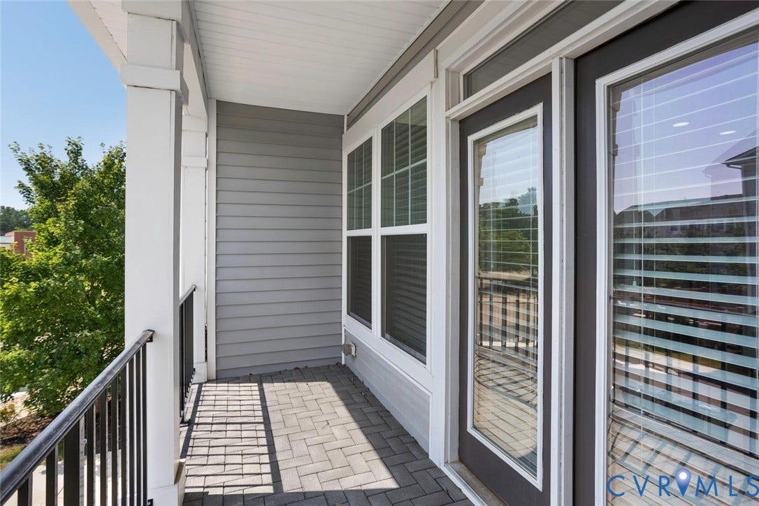 10420 Perennial Drive, Ridgefield Green Townhome, Henrico, VA 23233 Outdoor balcony featuring gray siding, white trim, and a black wrought iron railing