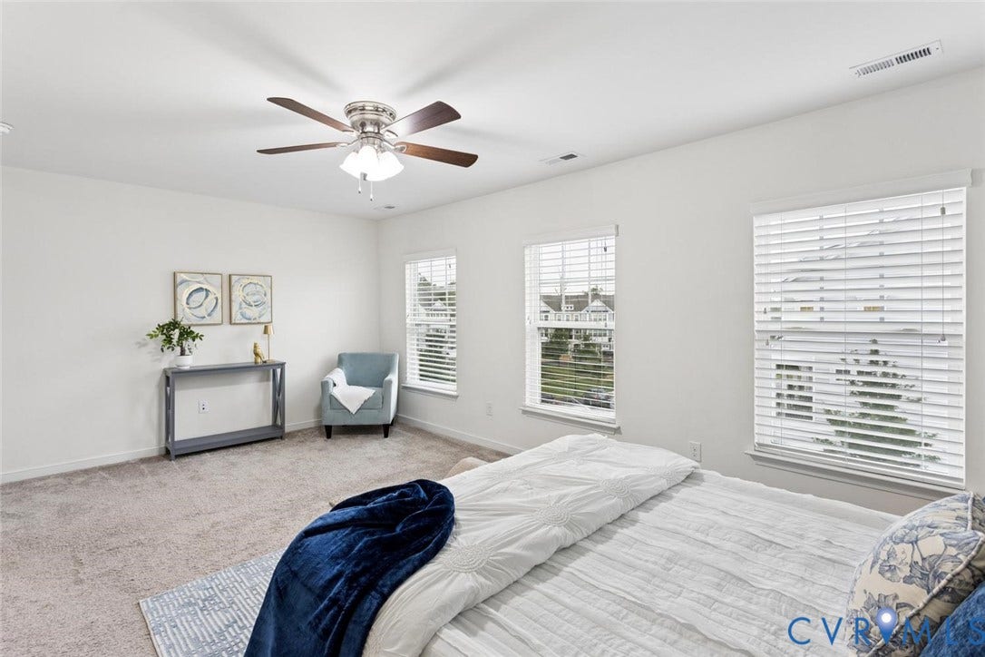 10420 Perennial Drive, Ridgefield Green Townhome, Henrico, VA 23233 Recessed lighting, ceiling fan with light fixture, multiple windows with blinds, and neutral carpeting