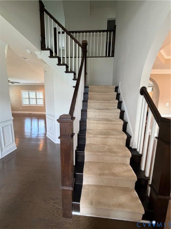 12146 Elnora Lane, Glen Allen, VA 23059 Staircase featuring dark wood newel posts and railings, white balusters, and a carpet runner