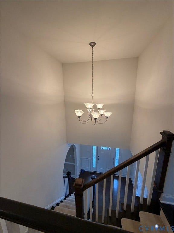 12146 Elnora Lane, Glen Allen, VA 23059 Two-story entry with a decorative chandelier, arched doorways, and a dark wood-finish handrail with white balusters