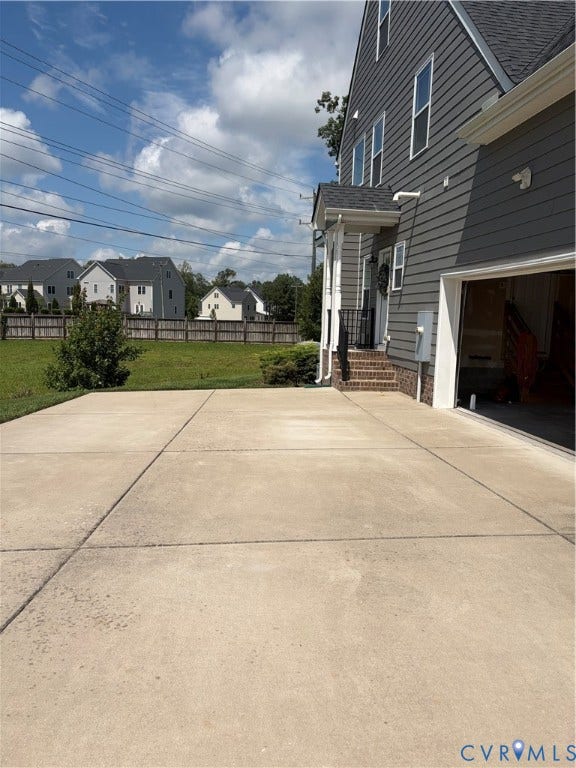 12146 Elnora Lane, Glen Allen, VA 23059 Concrete driveway with segmentation, leading to a side-entry garage and a covered porch with white columns