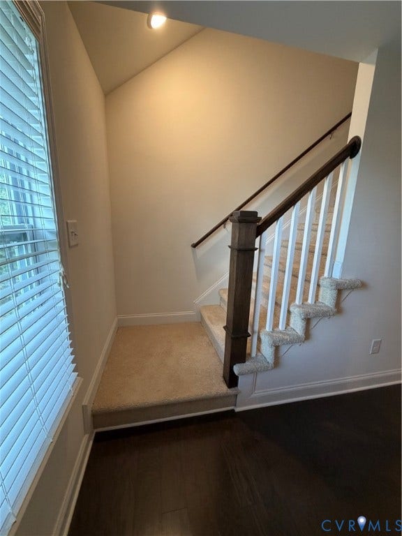 12146 Elnora Lane, Glen Allen, VA 23059 Wood-finish flooring, carpeted staircase with white risers, dark wood newel post and handrail, and a window with horizontal blinds