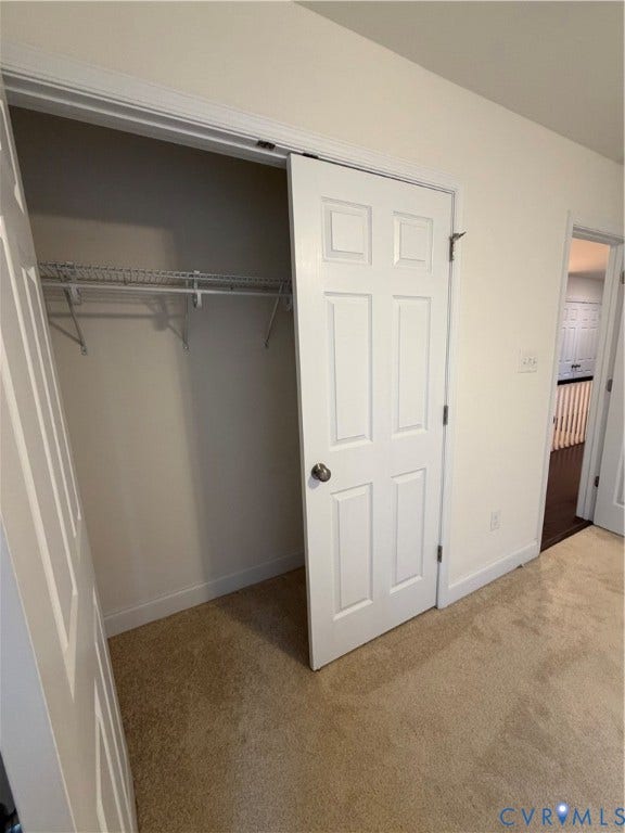 12146 Elnora Lane, Glen Allen, VA 23059 Sliding closet door with chrome hardware, featuring interior wire shelving, light-colored carpeting, and white trim