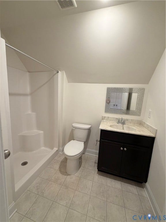 12146 Elnora Lane, Glen Allen, VA 23059 White shower enclosure, toilet, dark wood-finish vanity with an integrated sink, polished chrome faucet, and a decorative framed mirror