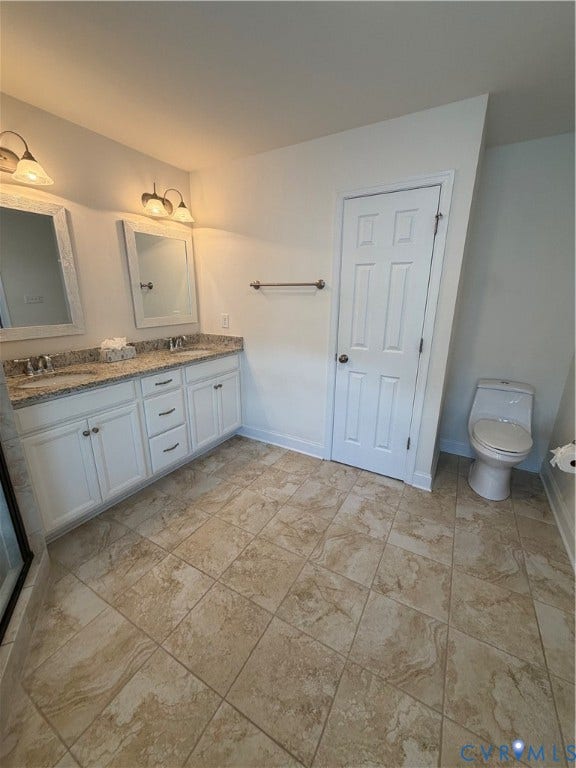 12146 Elnora Lane, Glen Allen, VA 23059 Dual vanity with undermount sinks, speckled countertop, white cabinetry, and tile flooring