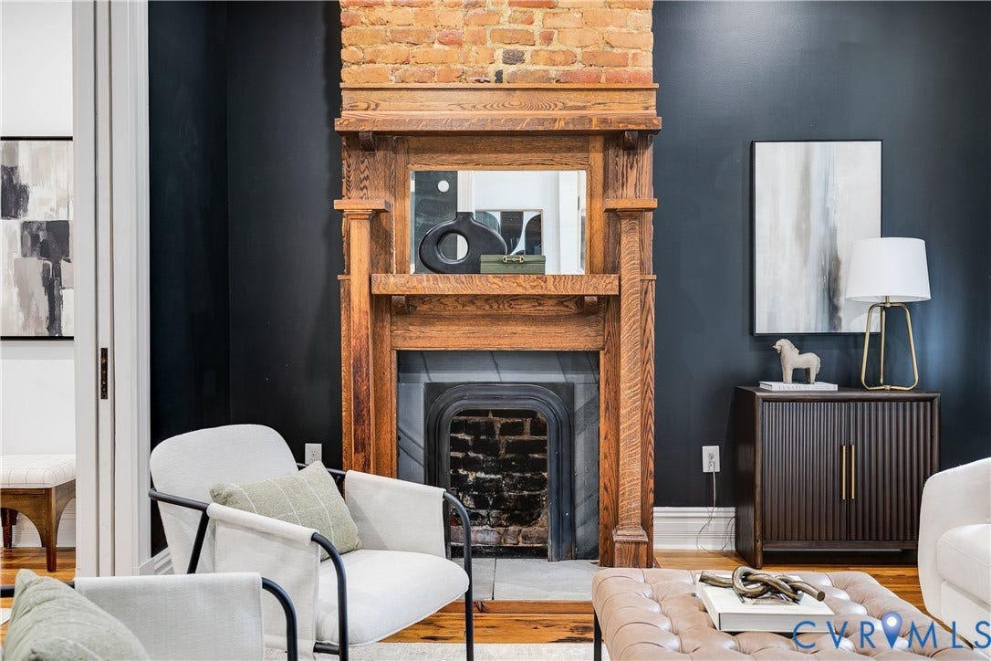 1416 Oakwood Avenue, Church Hill, Richmond, VA 23223 Ornate wood-crafted fireplace mantel with an exposed brick surround, featuring a cast-iron firebox