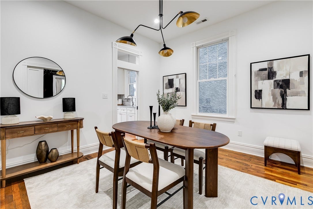1416 Oakwood Avenue, Church Hill, Richmond, VA 23223 Hardwood flooring, crisp white walls, and a contemporary multi-arm chandelier create a bright dining area