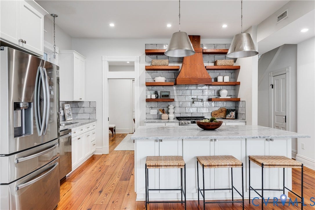1416 Oakwood Avenue, Church Hill, Richmond, VA 23223 Kitchen featuring stainless steel appliances, white cabinetry, a large center island with seating, a subway tile backsplash, and wood-finish flooring