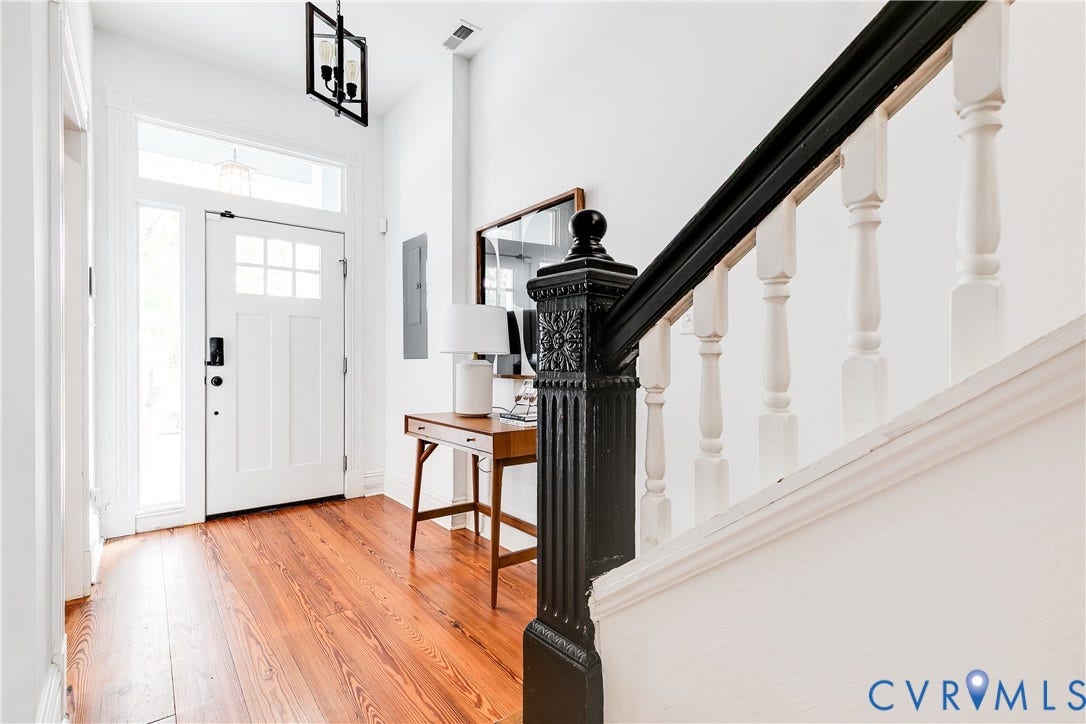 1416 Oakwood Avenue, Church Hill, Richmond, VA 23223 Entryway featuring hardwood flooring, a paneled door with transom window and sidelight, a decorative newel post, and white balusters