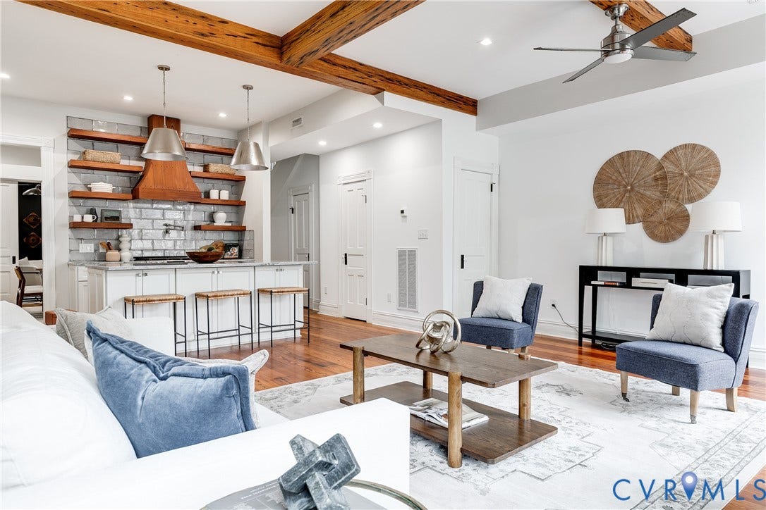 1416 Oakwood Avenue, Church Hill, Richmond, VA 23223 Exposed wood beams, recessed lighting, wood-finish flooring, white cabinetry, and a kitchen island with seating