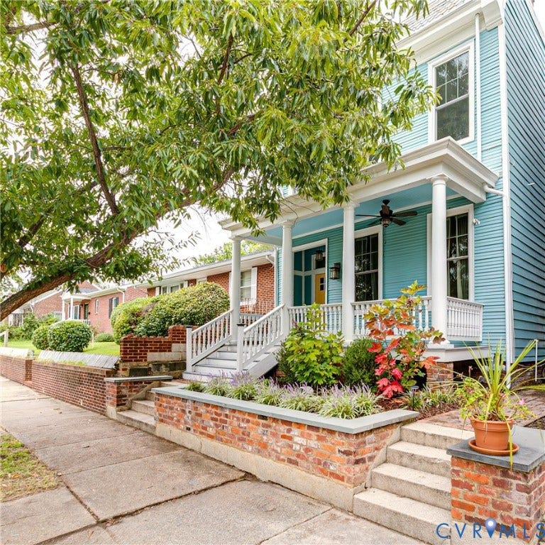 1416 Oakwood Avenue, Church Hill, Richmond, VA 23223 Vibrant blue siding exterior with a welcoming covered porch, white pillars, and a ceiling fan
