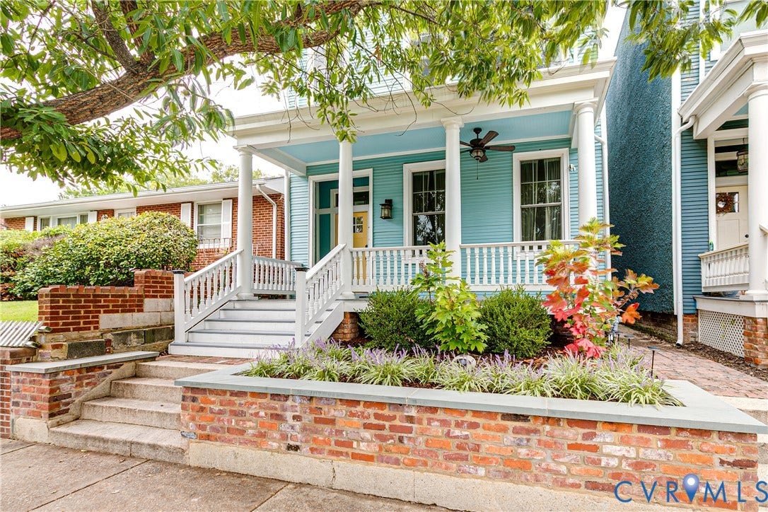 1416 Oakwood Avenue, Church Hill, Richmond, VA 23223 Exterior featuring a vibrant facade, columned front porch, white balustrade, and brick retaining walls