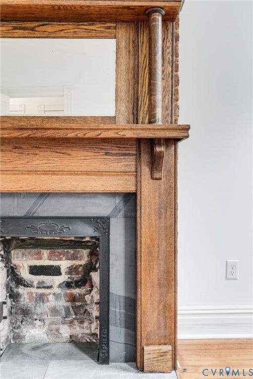 1416 Oakwood Avenue, Church Hill, Richmond, VA 23223 Wood-finish mantel with integrated mirror, brick fireplace interior, and a cast-iron firebox surround