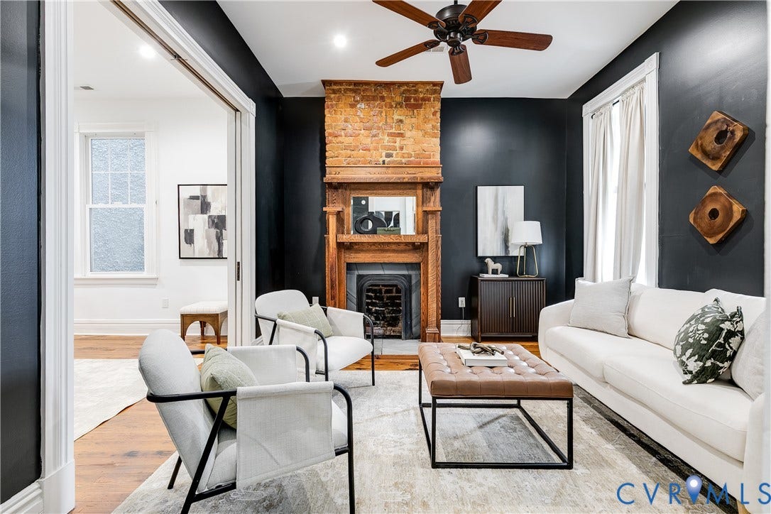 1416 Oakwood Avenue, Church Hill, Richmond, VA 23223 Brick fireplace with an ornate wood mantel, wood-finish flooring, and a ceiling fan with integrated lighting