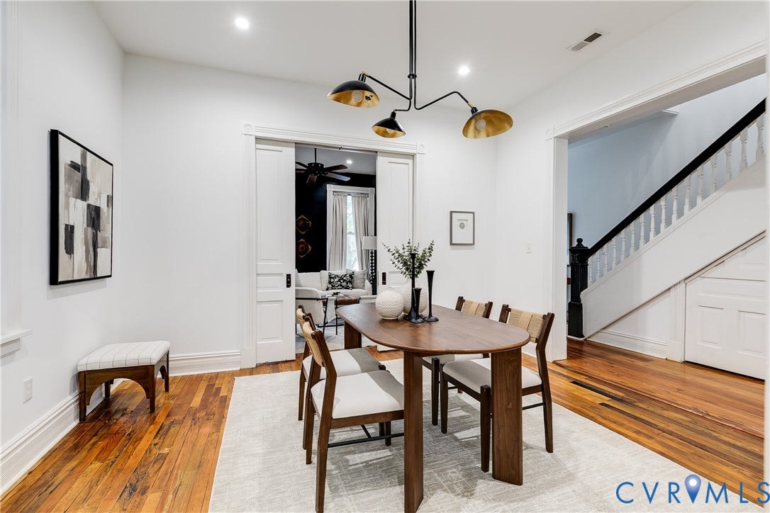 1416 Oakwood Avenue, Church Hill, Richmond, VA 23223 Hardwood flooring, overhead lighting, white trim, white walls, and a staircase with a dark wood handrail