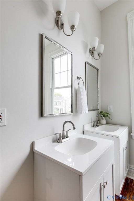 1416 Oakwood Avenue, Church Hill, Richmond, VA 23223 Dual vanity with white cabinetry, integrated sinks, brushed nickel fixtures, and coordinating wall-mounted sconces
