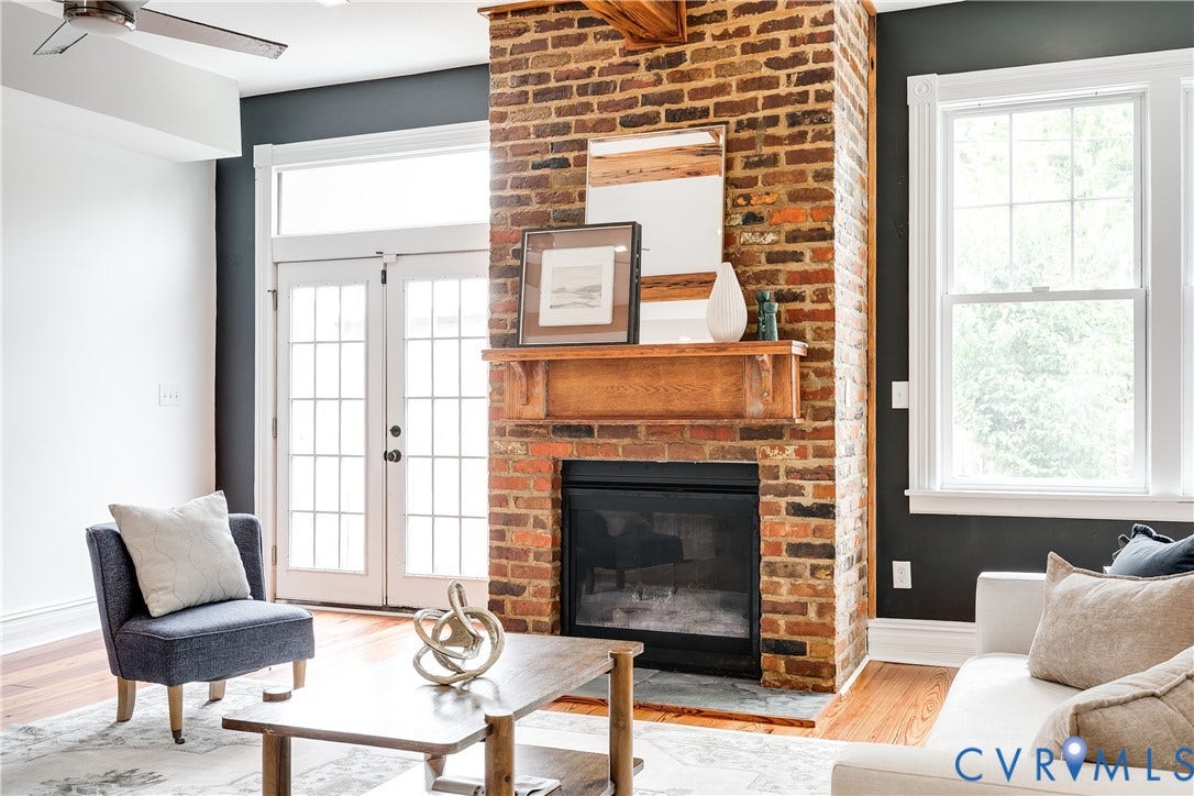 1416 Oakwood Avenue, Church Hill, Richmond, VA 23223 Brick fireplace with wood mantel, double French doors, wood-finish flooring, and a ceiling fan