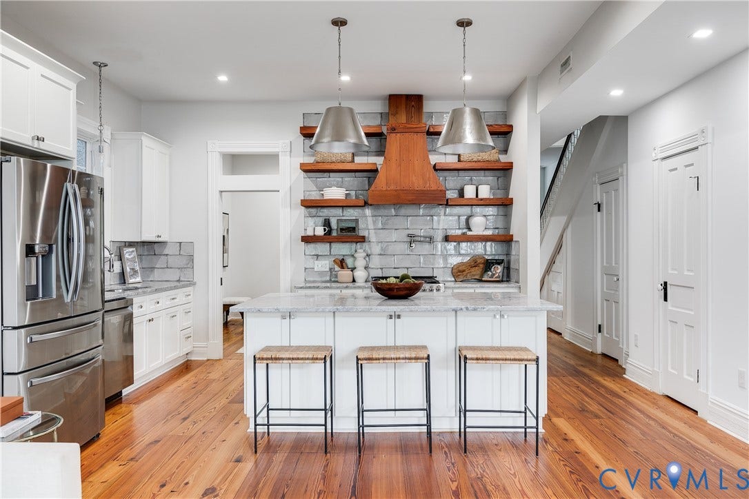 1416 Oakwood Avenue, Church Hill, Richmond, VA 23223 Gourmet kitchen featuring a center island, white cabinetry, wood-finish flooring, stainless steel appliances, and a tile backsplash