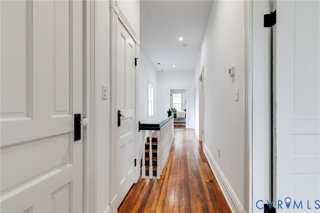 1416 Oakwood Avenue, Church Hill, Richmond, VA 23223 Hardwood flooring, recessed lighting, white panel doors, white trim, and a white painted banister