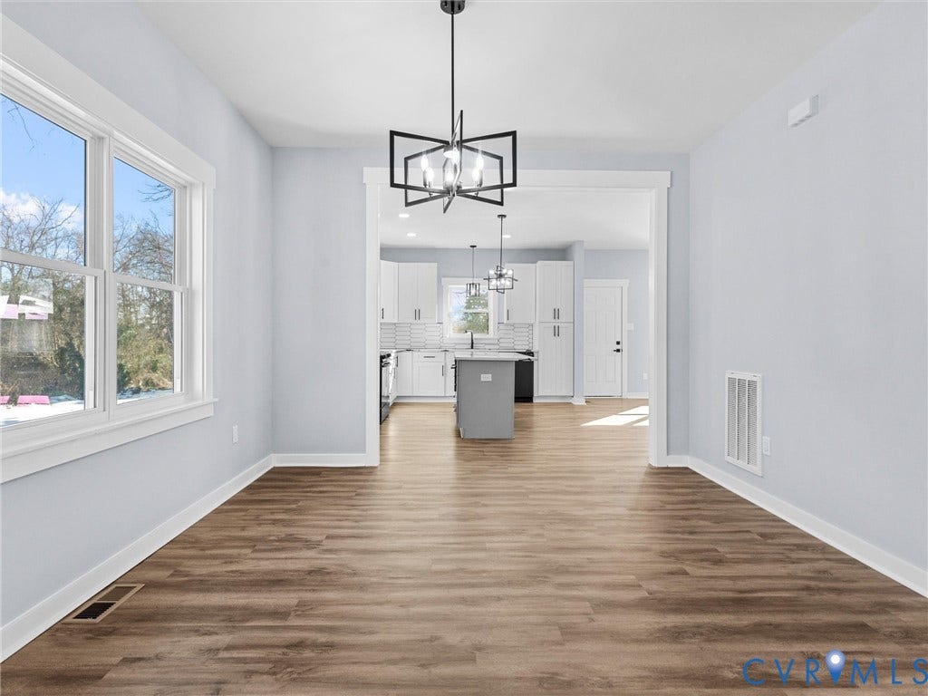 2719 General Boulevard, Chesterfield, VA 23237 Wood-finish flooring, white trim, and a contemporary chandelier