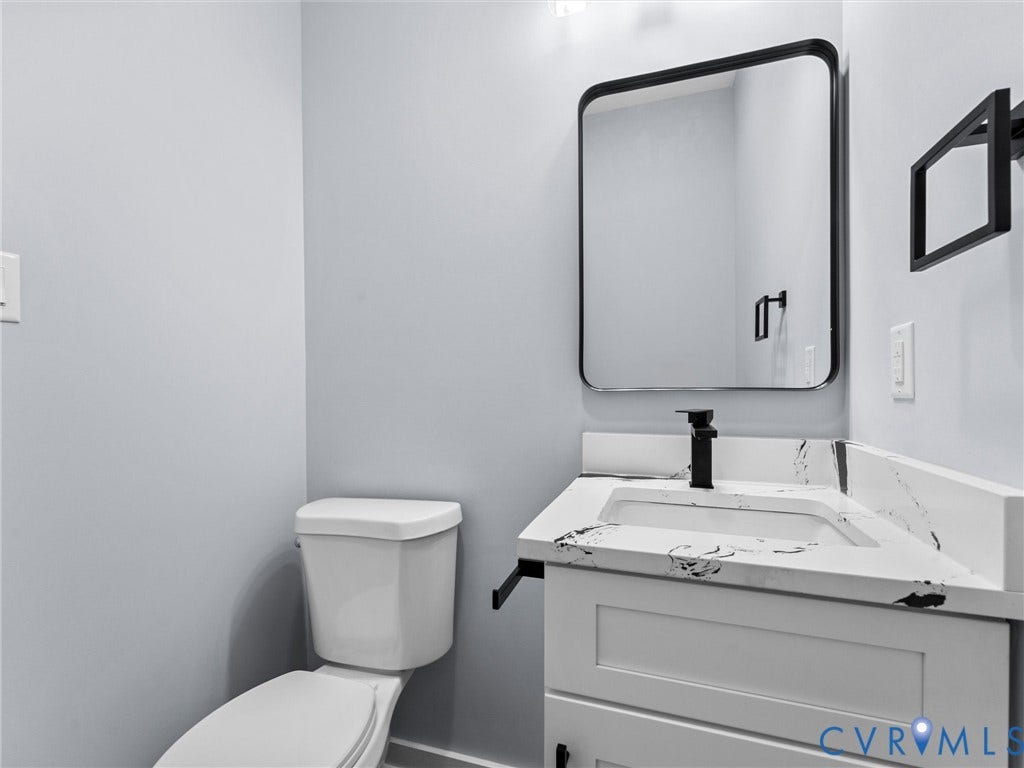 2719 General Boulevard, Chesterfield, VA 23237 Vanity with integrated sink, matte black faucet, framed mirror, and white cabinetry