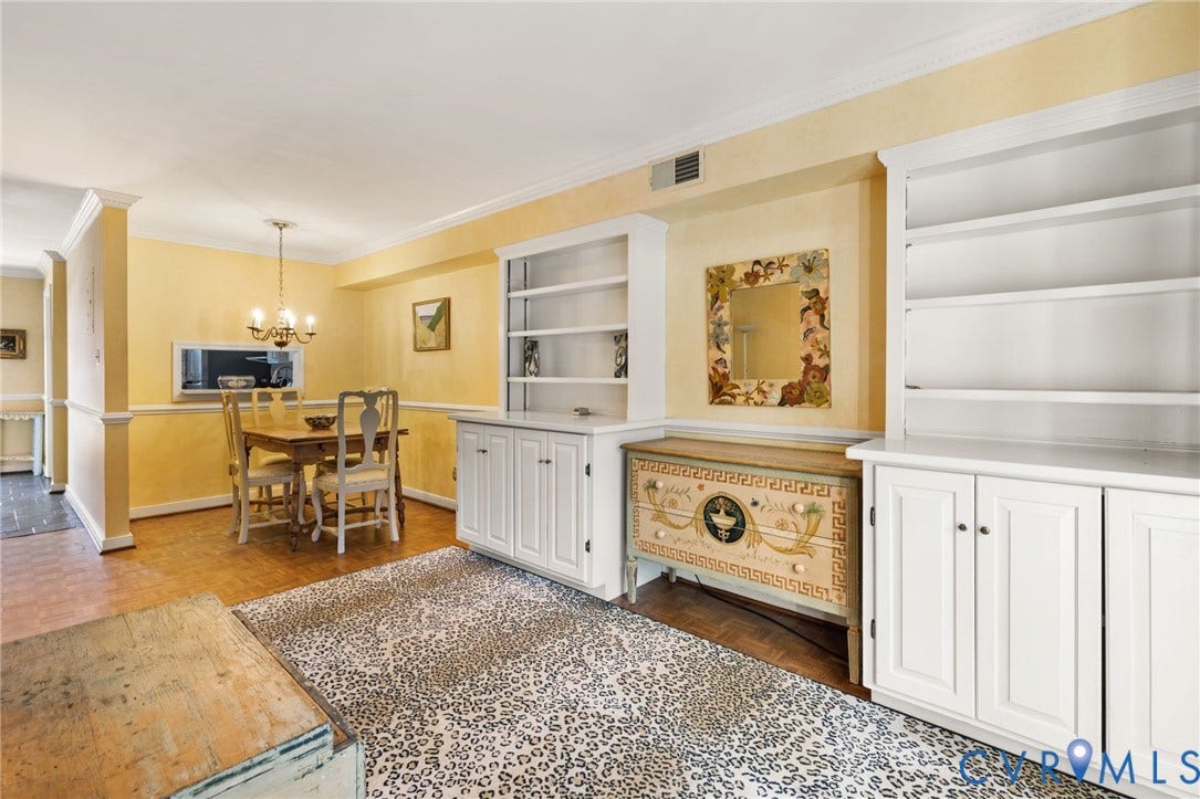 505 N Hamilton Street, #F, Richmond, VA 23221 Wood-finish flooring, built-in shelving, crown molding, and a chandelier lighting fixture