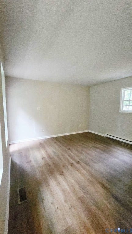 3807 Mooring Way, Chester, VA 23831 Wood-finish flooring with white trim, light-toned walls, and a window providing natural light