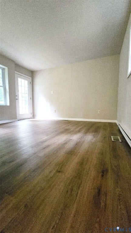 3807 Mooring Way, Chester, VA 23831 Wood-finish flooring with a white trim, neutral wall paint, and a door with multiple glass lites