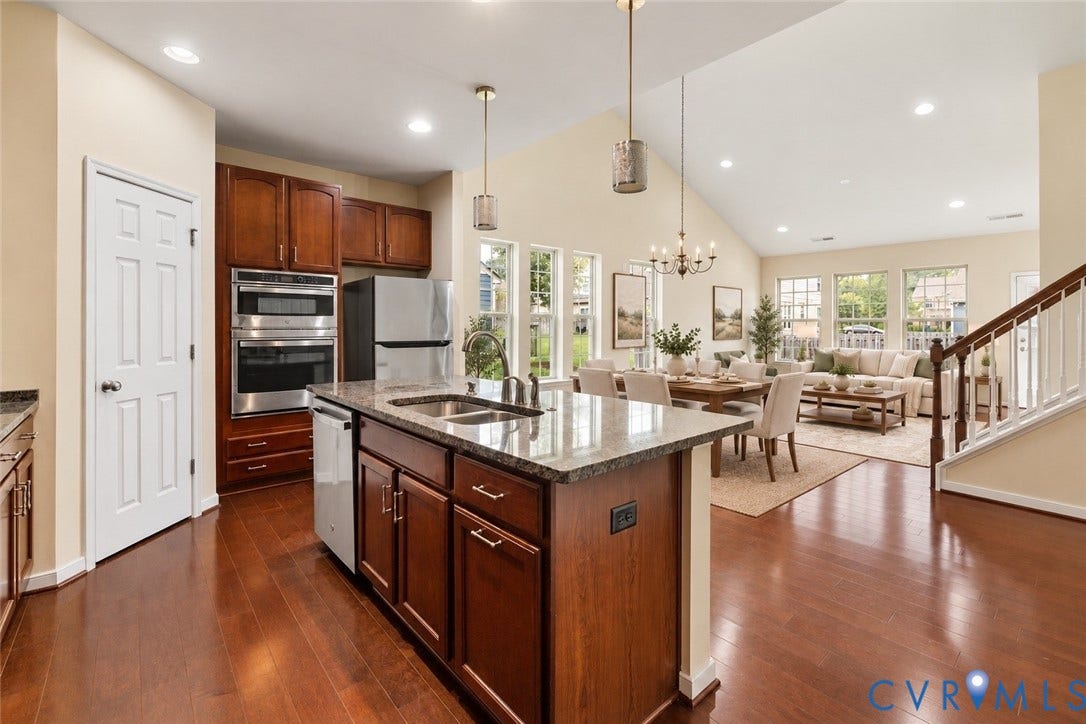 508 Winterhawk Place, Glen Allen, VA 23059 Open-concept living area featuring a kitchen island, wood-finish flooring, vaulted ceiling, and recessed lighting