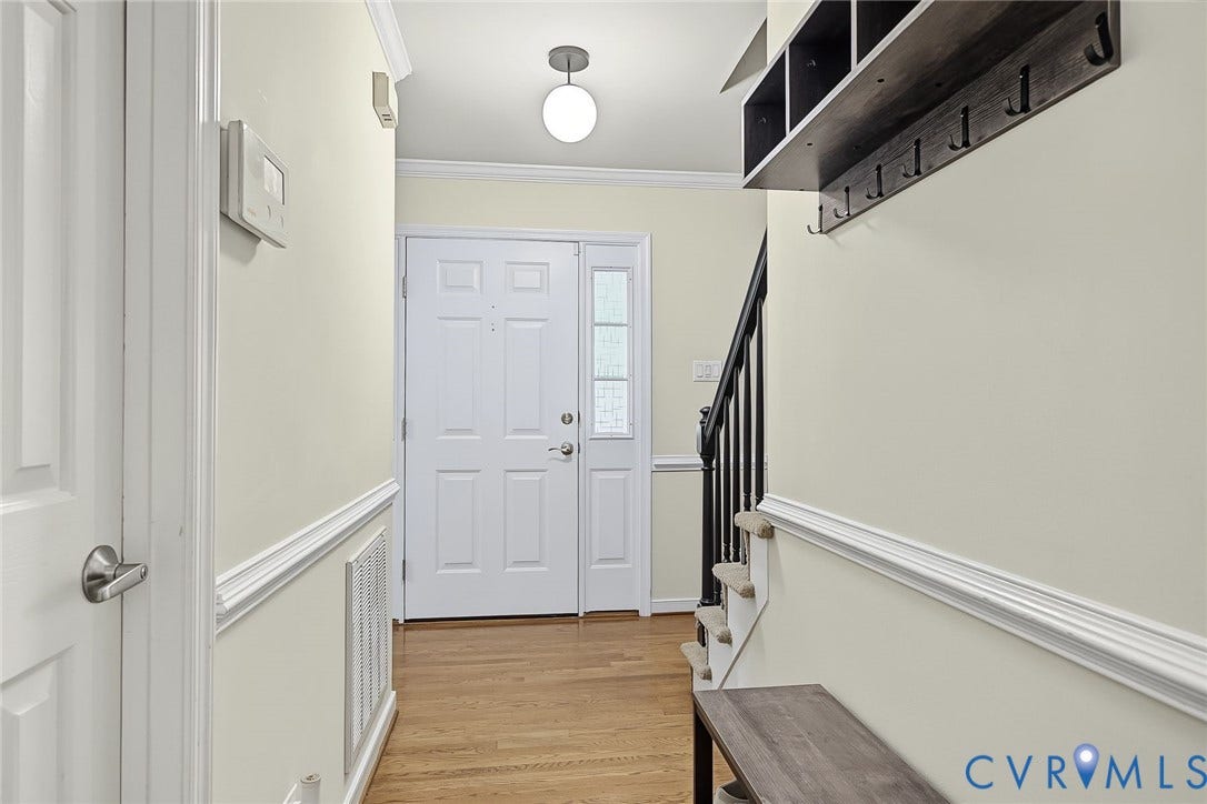 4706 Jacobs Glenn Drive, North Chesterfield, VA 23236 Hardwood flooring, crown molding, chair rail, and updated lighting make for a classic entry