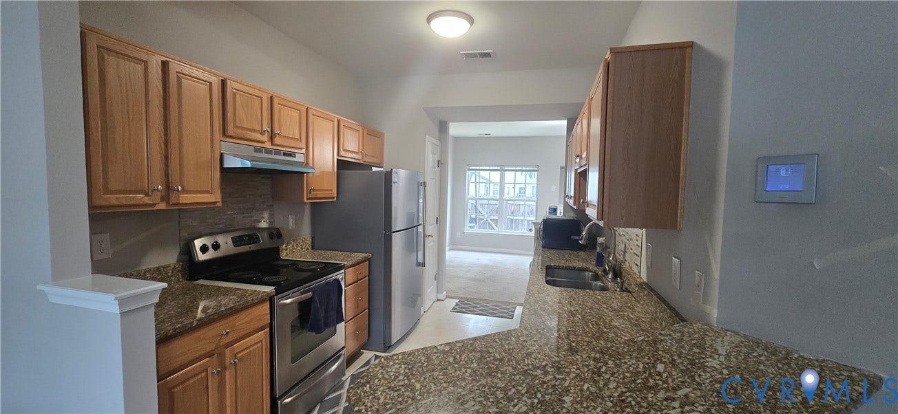 5506 Millwheel Lane, Henrico, VA 23228 Kitchen featuring wood cabinetry, stainless steel appliances, speckled countertops, and a tiled backsplash