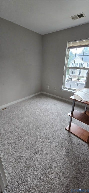5506 Millwheel Lane, Henrico, VA 23228 Carpeted room with a large window and neutral wall tones