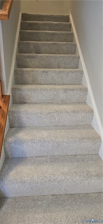 5506 Millwheel Lane, Henrico, VA 23228 Staircase with light gray carpeting, white painted risers, and a wood handrail