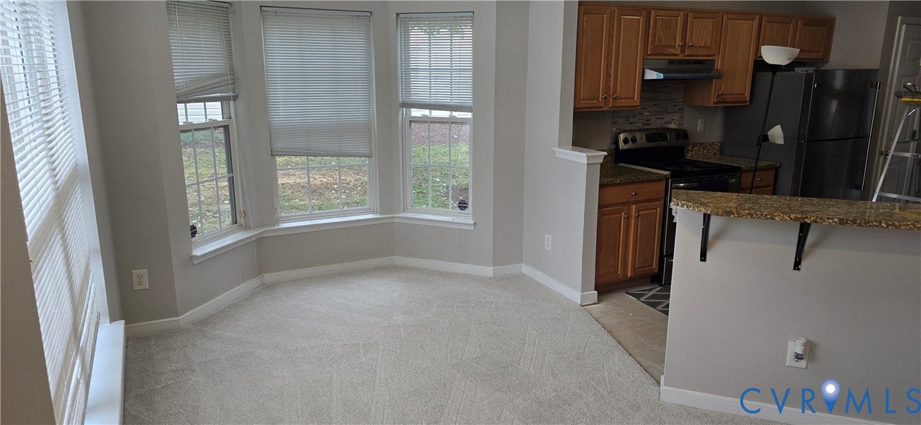 5506 Millwheel Lane, Henrico, VA 23228 Bay window with multiple windows, light neutral wall paint, and light-toned carpeting